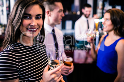 Portrait of woman having a drink with friends Portrait of woman having a drink with friends