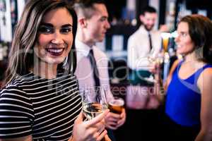 Portrait of woman having a drink with friends
