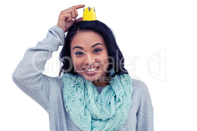 Asian woman pointing her paper crown