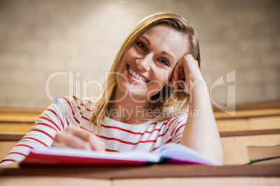 Female student taking notes in a class