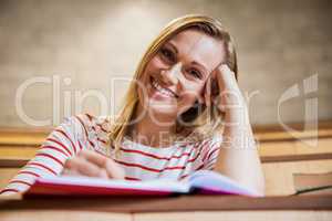 Female student taking notes in a class