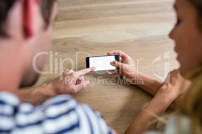 Focused couple using smartphone