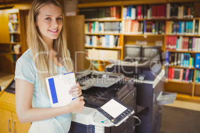 Smiling blonde student making a copy