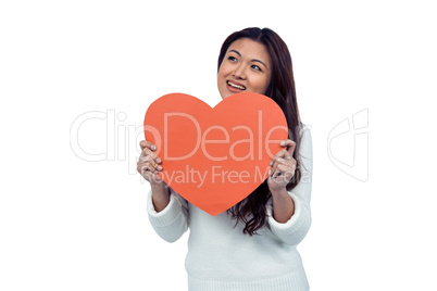 Smiling Asian woman holding paper heart