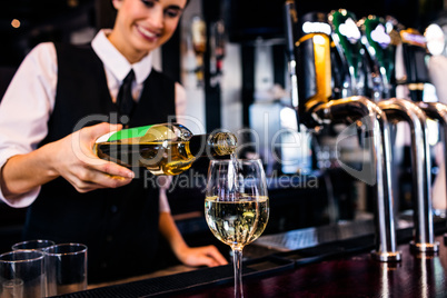 Barmaid serving a glass of wine