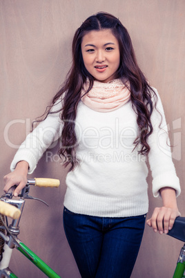 Asian woman holding bike