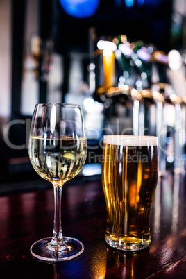 Close up of a glass of wine and a beer