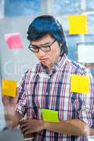 Creative businessman writing on sticky notes