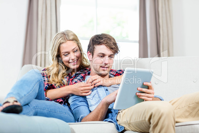 Couple using tablet computer