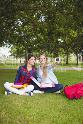 Smiling students taking a selfie outdoor