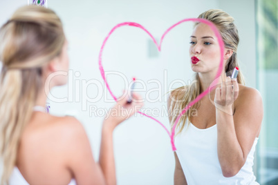 Woman applying lipstick