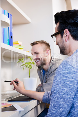 Happy gay couple using laptop