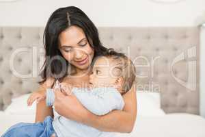 Happy brunette holding her baby