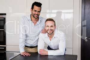 Smiling gay couple in the kitchen
