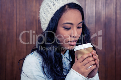 Asian woman holding disposable cup