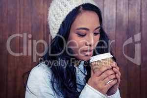 Asian woman holding disposable cup