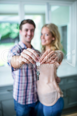 Cute couple showing their new home keys