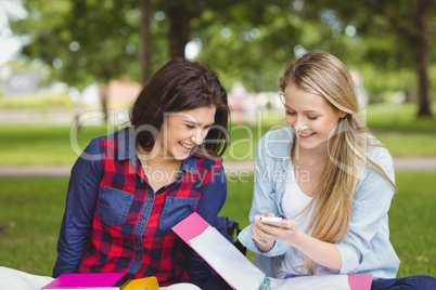 Smiling students using smartphone