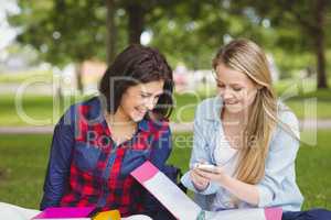 Smiling students using smartphone