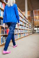 Female student walking in the library
