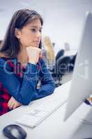 Serious student working on computer