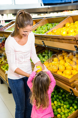 Mother and daughter taking fruit
