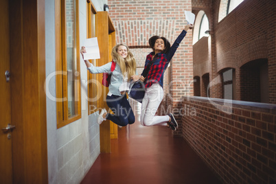 Happy female students receiving results