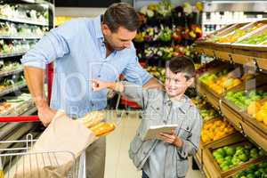 Father and son doing grocery shopping