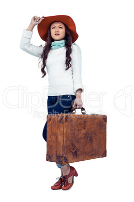 Asian woman with hat holding luggage