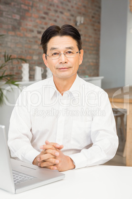 Smiling man using laptop