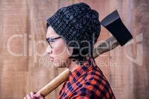 Side view of hipster holding a axe