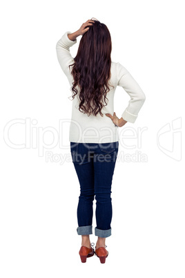 Rear view of brunette with hand on hair
