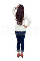 Rear view of brunette with hand on hair