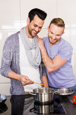 smiling gay couple preparing food