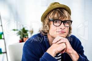 Thoughtful hipster businessman looking at the camera