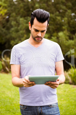 Serious man using tablet