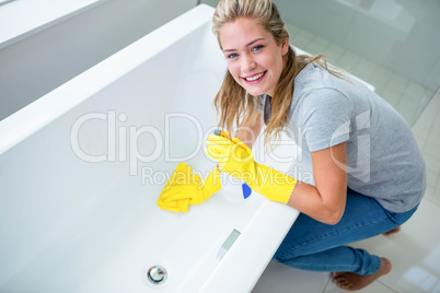 Woman cleaning the bath tub