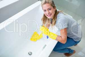 Woman cleaning the bath tub