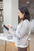 Serious pregnant woman using tablet