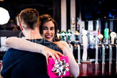 Couple hugging in a bar