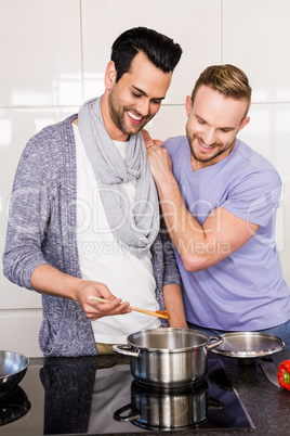 smiling gay couple preparing food