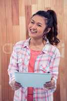 Smiling Asian woman using tablet