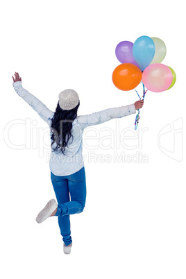 Asian woman holding colorful balloons