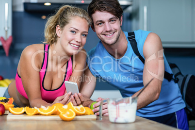 Healthy couple looking at smartphone