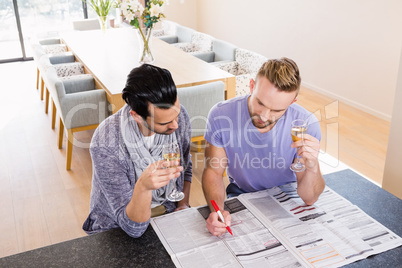 Smiling gay couple surrounding ads