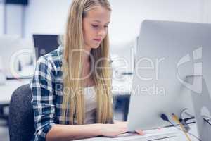 Serious student working on computer