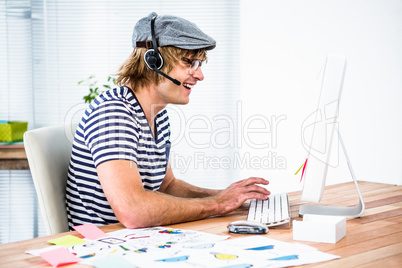 Smiling hipster businessman using headset