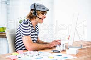 Smiling hipster businessman using headset