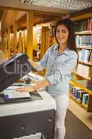 Smiling brunette student making a copy