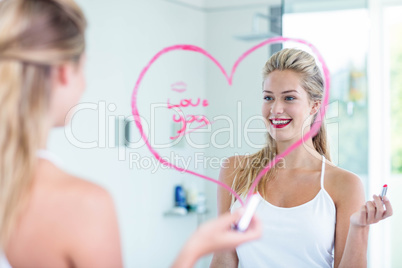 Woman writing on the mirror with lipstick